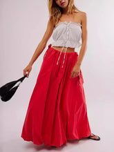 Load image into Gallery viewer, Woman wearing Boho maxi skirt with side bow tie and pockets in red. Front view - Gypsy Collection women's skirt