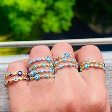 Load image into Gallery viewer, Evil Eye 🧿 dark blue iris with gold and silver band rings stacked on model: Ward Off Evil from your life with this easy to wear Evil Eye Ring. The eye protects it’s wearer from jealousy, bad luck and ill wishes from others. Jewelry gift. Boho Jewelry. Evil eye ring. Evil eye jewelry. The Gypsy Collection - Lucky Birds Boutique