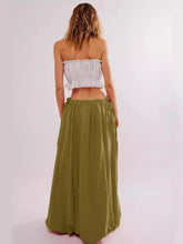 Load image into Gallery viewer, Woman wearing Boho maxi skirt with side bow tie and pockets in olive green. Rear view - Gypsy Collection women&#39;s skirt
