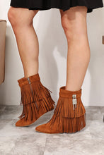 Load image into Gallery viewer, Women&#39;s western wedge ankle booties with side tassels in faux suede on model. side view of lock embellishment- Jolene Collection &#39;Legend&#39; boots.
