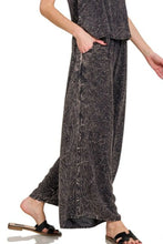 Load image into Gallery viewer, Women&#39;s acid washed camp 2-piece outfit with crinkle woven cami top and matching pants on model- side view closeup of wide let pants - Valerie Collection Zenana set
