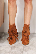 Load image into Gallery viewer, Women&#39;s western wedge ankle booties with side tassels in faux suede on model. Front view of pointed toe - Jolene Collection &#39;Legend&#39; boots.
