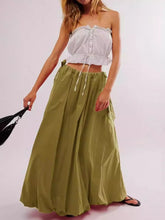 Load image into Gallery viewer, Woman wearing Boho maxi skirt with side bow tie and pockets in olive green. Front view - Gypsy Collection women&#39;s skirt
