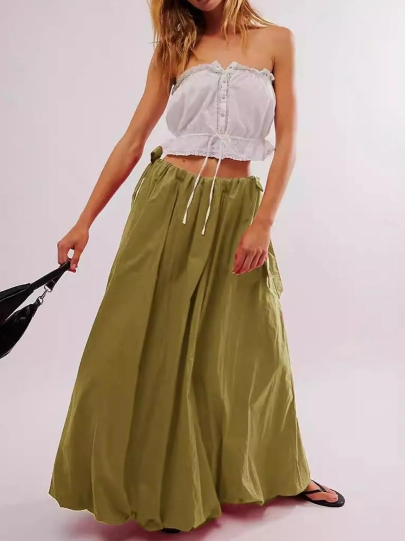 Woman wearing Boho maxi skirt with side bow tie and pockets in olive green. Front view - Gypsy Collection women's skirt