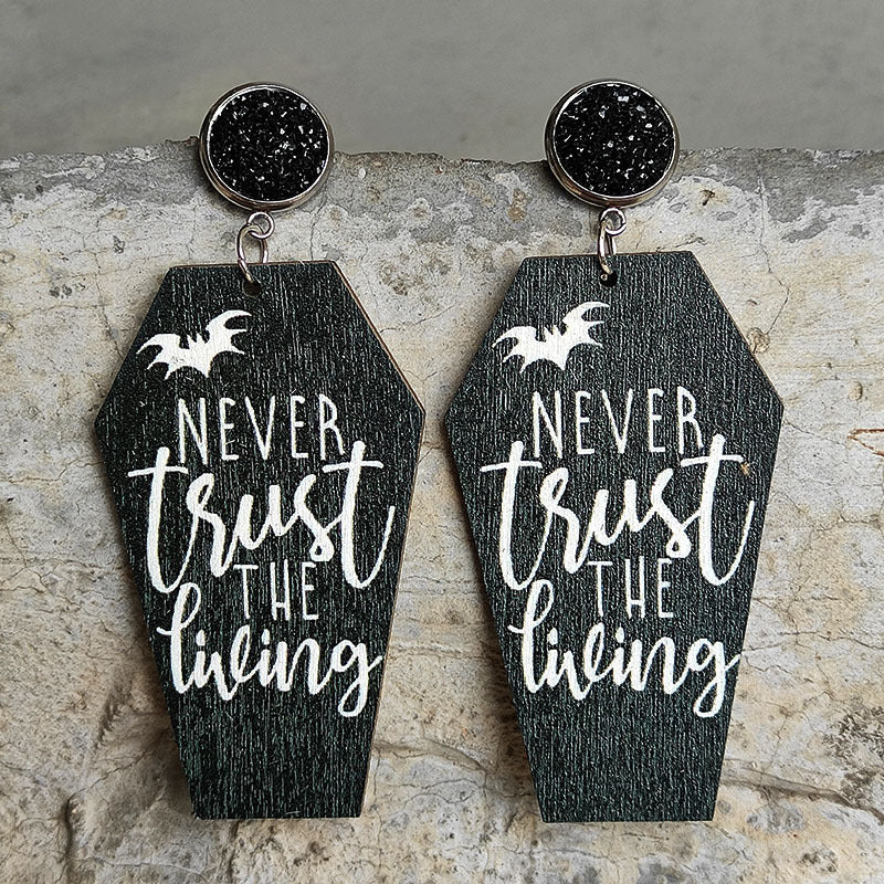 2023 Halloween style. Halloween Earrings: coffin shaped with script 'Never trust the lineing'. cenimatic themed earrings perfect for the Holiday Season and Spooky Vibes
