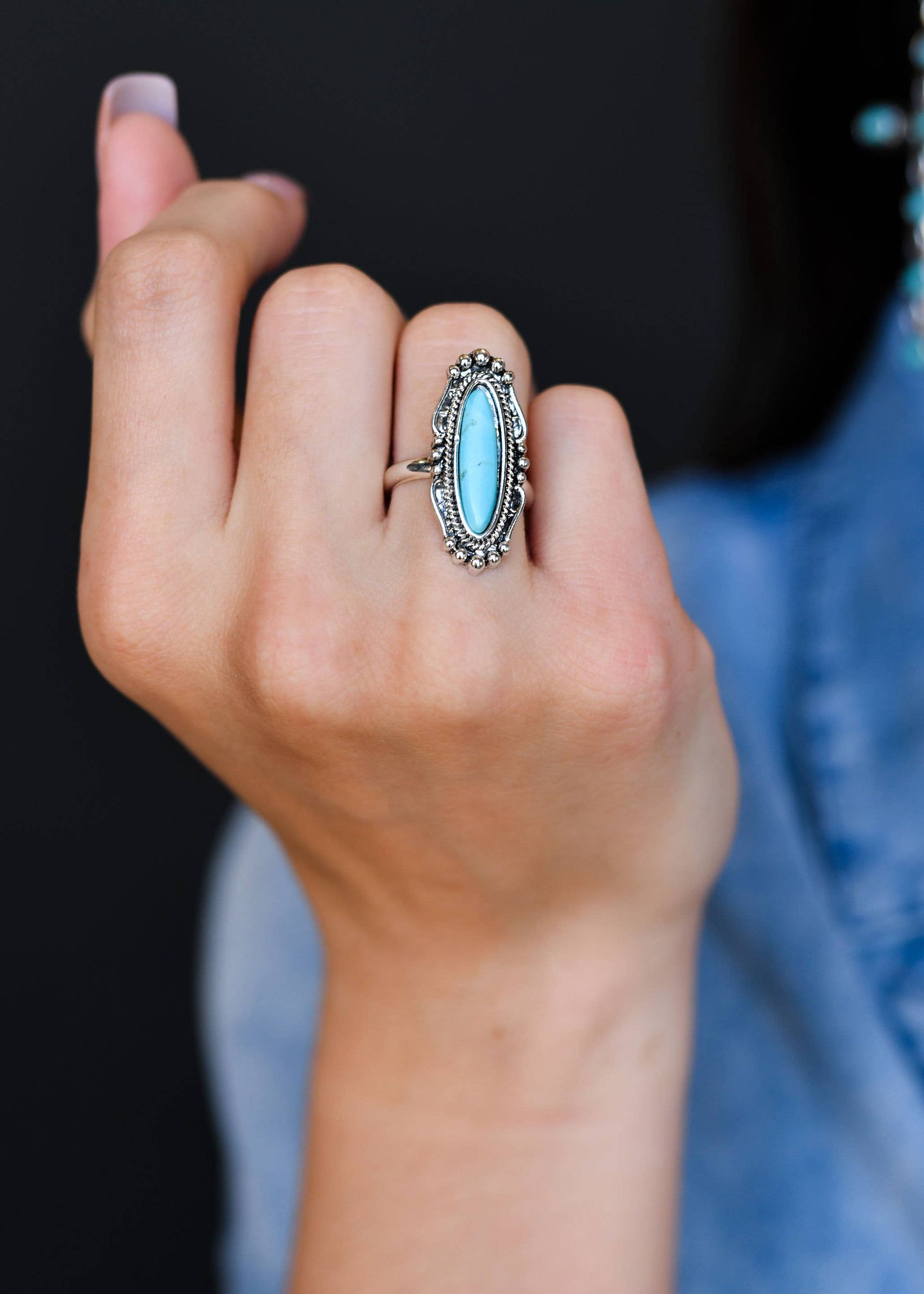 Burnished silver Navajo inspired ring with turquoise stone on model. Perfect addition to western jewelry set or part of your BOHO ring collection. Turquoise ring. Western rings for women. Bohemian ring. The Jolene Collection - Lucky Birds Boutique