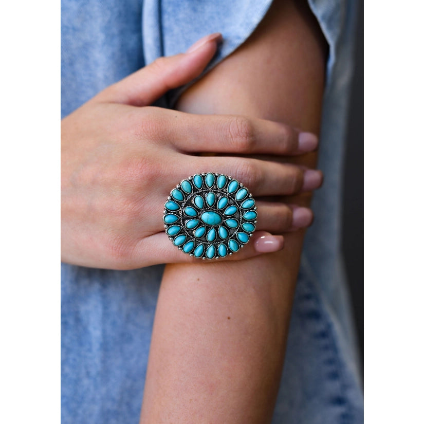 Adjustable turquoise cluster ring on model. Spice up your accessories with this western style statement ring. This versatile ring fits most fingers. Western ring. Turquoise Rings. Turquoise Statement Rings. Women's Ring. Trending Jewelry. The Jolene Collection - Lucky Birds Boutique