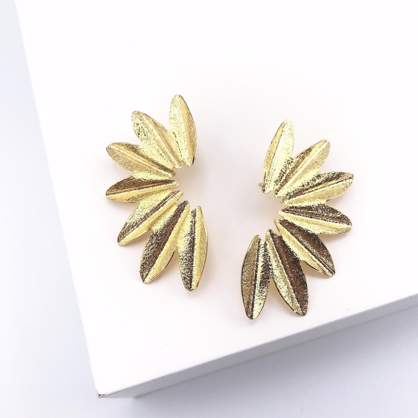 24K Gold plated floral earrings. Semi-circle design, elegantly frames the face. High Quality Earrings. Lucky Birds Boutique Jewelry. The Bae Collection. 