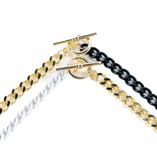 half n' half curb chain necklaces. White and gold necklace & Black and gold necklace. Up-close toggle closure. Lucky Birds Boutique. The Valerie Collection. 