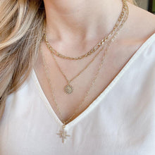 Load image into Gallery viewer, Chic Triple chain necklace. 18K gold plated layered necklace. North star pendant and crystal flower pendant - on model. Lucky Birds necklaces for women. Lolita Collection. 
