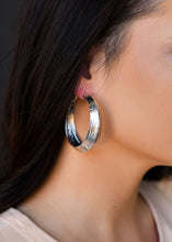 Load image into Gallery viewer, Burnished silver hoop earrings on model. The beautifully tooled design adds an extra special element that makes these silver earrings a must have in your western accessories closet. Silver Jewelry. Hoop Earrings. Western Earrings for women. The Jolene Collection - Lucky birds Boutique
