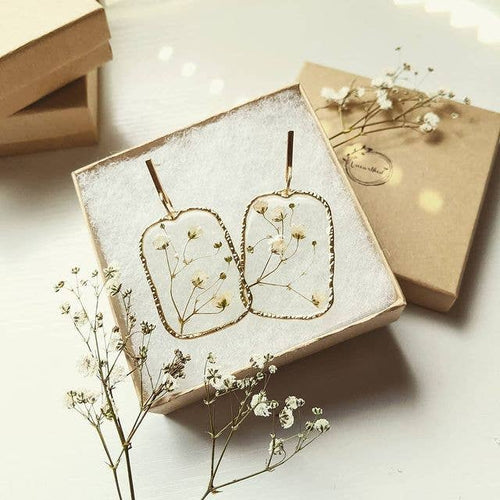 Real, dried baby's breath that is encapsulated in resin. Handmade by Unearthed, Custom made designs with unique variations in each set. Nature Earrings to nurture your BOHO style. Bohemian Earrings. Gypsy earrings. Natural jewelry for women. The Gypsy Collection - Lucky Birds Boutique