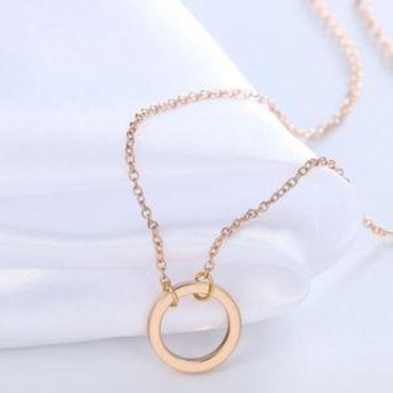 Sleek, low profile, minimalist gold necklace with circle pendant. Women's necklace for daily go-to accessory. 